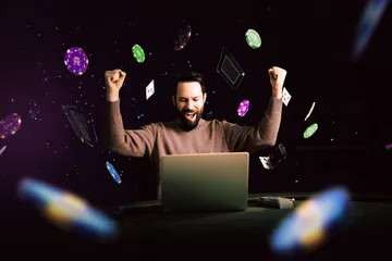 A man celebrating a winning moment on his laptop while gaming symbols float around him, capturing the excitement of JILI69 games.