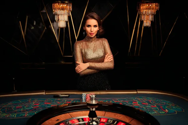 JILI69 Slots — Thousands of thrilling machines await A woman smiling by bright slot machines showing lucky symbols, showcasing the exciting slot offerings at JILI69.